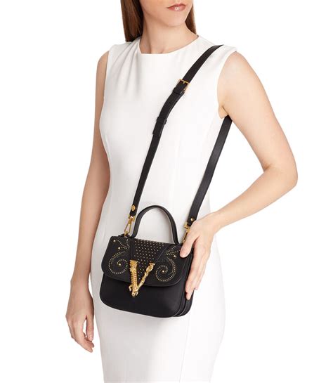 versace bolsa dorada con estoperol|farfetch versace.